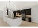 Modern kitchen with granite counters, stainless steel appliances, and dark wood cabinets at 19798 Cobblestone Cir, Venice, FL 34292