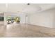 Open living room with high ceilings, tile floors, and sliding doors to outdoor living space at 19798 Cobblestone Cir, Venice, FL 34292