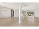 Spacious living room featuring tile floors, high ceilings, and an open floor plan at 19798 Cobblestone Cir, Venice, FL 34292