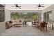 Spacious screened-in patio with ceiling fans, dining and lounge area at 19798 Cobblestone Cir, Venice, FL 34292