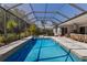 An inviting screened-in pool and spa with lush backyard landscaping at 19798 Cobblestone Cir, Venice, FL 34292