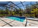 Screened in pool and spa surrounded by beautiful landscaping at 19798 Cobblestone Cir, Venice, FL 34292