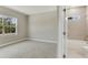 Bright bedroom with plush carpet and a view of the outdoors from the large window at 2290 Beeville Ave, North Port, FL 34286