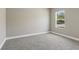 Bedroom bathed in light with plush carpeting, and a scenic outdoor view from the window at 2290 Beeville Ave, North Port, FL 34286