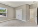 Bright bedroom featuring carpeting, closet space, and natural light from the window at 2290 Beeville Ave, North Port, FL 34286