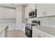 This kitchen features granite counters, tile backsplash, and stainless steel appliances at 2290 Beeville Ave, North Port, FL 34286