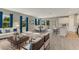 Open-concept living room and dining area with lots of natural light and hardwood floors at 2290 Beeville Ave, North Port, FL 34286
