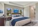Spacious main bedroom features a tray ceiling, two windows, and calming decor at 2290 Beeville Ave, North Port, FL 34286