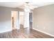 Spacious bedroom with modern ceiling fan, wood floors, closet and bathroom entrances at 2300 Stickney Point Rd # 125, Sarasota, FL 34231