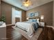 Comfortable bedroom featuring a ceiling fan, wood floors, and decoratively staged with stylish furnishings at 2300 Stickney Point Rd # 125, Sarasota, FL 34231