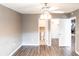 Bright bedroom featuring a ceiling fan, wood floors, bathroom and walk-in closet at 2300 Stickney Point Rd # 125, Sarasota, FL 34231