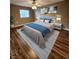 Comfortable bedroom featuring a ceiling fan, wood floors, and decoratively staged with stylish furnishings at 2300 Stickney Point Rd # 125, Sarasota, FL 34231