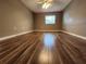 A standard-sized bedroom featuring a ceiling fan, neutral paint and hard wood floors at 2300 Stickney Point Rd # 125, Sarasota, FL 34231