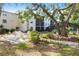 Community area featuring a seating area and pathway leading towards the enclosed pool area at 2300 Stickney Point Rd # 125, Sarasota, FL 34231
