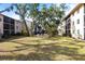 Spacious common area with mature trees and a charming outdoor sitting area at 2300 Stickney Point Rd # 125, Sarasota, FL 34231