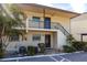 Charming condo exterior featuring a two-story building with well-maintained landscaping and stairs to the second level at 2300 Stickney Point Rd # 125, Sarasota, FL 34231
