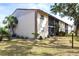 Well-maintained exterior of the property with screened in lanais and lush tropical landscaping at 2300 Stickney Point Rd # 125, Sarasota, FL 34231