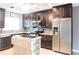 Updated kitchen featuring granite countertops, stainless steel appliances, and a movable prep island at 2300 Stickney Point Rd # 125, Sarasota, FL 34231