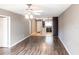 Spacious living area showing hardwood flooring, updated ceiling fans, and a view to the kitchen at 2300 Stickney Point Rd # 125, Sarasota, FL 34231