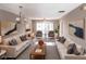 Bright and airy living room featuring neutral decor, plush seating, and access to a balcony for outdoor enjoyment at 2300 Stickney Point Rd # 125, Sarasota, FL 34231