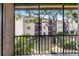 Screened patio view of tropical landscaping and exterior of complex at 2300 Stickney Point Rd # 125, Sarasota, FL 34231