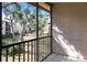 Screened patio featuring a lovely view of mature trees and exterior of community at 2300 Stickney Point Rd # 125, Sarasota, FL 34231