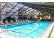 Serene enclosed community pool with ample lounge seating and refreshing water at 2300 Stickney Point Rd # 125, Sarasota, FL 34231