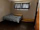 Bedroom with dark flooring and a bed with patterned bedding at 2503 23Rd W Ave, Bradenton, FL 34205