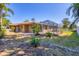 View of the backyard featuring the screened-in lanai and lush landscaping at 2536 Carlisle Pl, Sarasota, FL 34231