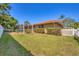 Large backyard featuring a screened-in lanai and well-manicured shrubbery at 2536 Carlisle Pl, Sarasota, FL 34231