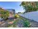 Expansive backyard view featuring lush greenery and a white fence at 2536 Carlisle Pl, Sarasota, FL 34231