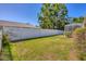 Fully fenced backyard featuring green grass and shrubbery at 2536 Carlisle Pl, Sarasota, FL 34231