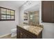 Granite vanity, custom cabinetry and modern fixtures in a well-lit bathroom at 2536 Carlisle Pl, Sarasota, FL 34231