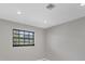 Well-lit bedroom featuring a window providing ample natural light and neutral wall color at 2536 Carlisle Pl, Sarasota, FL 34231