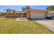 Welcoming home featuring a two-car garage, manicured lawn, and inviting front entrance at 2536 Carlisle Pl, Sarasota, FL 34231