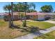 Charming single-story home with a well-manicured lawn and a vibrant orange tile roof at 2536 Carlisle Pl, Sarasota, FL 34231