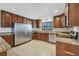 Well-equipped kitchen with stainless steel appliances, granite counters, and tile flooring at 2536 Carlisle Pl, Sarasota, FL 34231