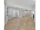 Open-concept living area with tile floors and archway to other rooms at 2536 Carlisle Pl, Sarasota, FL 34231