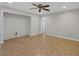 Open-concept living space with neutral color scheme, ceiling fan and tile floors at 2536 Carlisle Pl, Sarasota, FL 34231