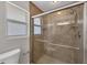 Tiled shower with glass doors, multiple shower heads, and stone accents in bathroom at 2536 Carlisle Pl, Sarasota, FL 34231