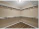 Spacious walk-in closet with wood floors and white shelving for optimal storage solutions at 2536 Carlisle Pl, Sarasota, FL 34231