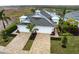 Aerial view showcasing a well-maintained home with lush landscaping and a driveway at 256 Van Gogh Cv, Bradenton, FL 34212