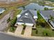 Stunning aerial view of a residential property with lush landscaping, a paved driveway, and a well-kept roof at 256 Van Gogh Cv, Bradenton, FL 34212