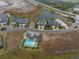 Overhead view of multiple homes, one with a private pool, in a meticulously landscaped community at 256 Van Gogh Cv, Bradenton, FL 34212