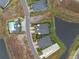 Bird's eye view of luxury residences with landscaped yards, driveways, and nearby water features at 256 Van Gogh Cv, Bradenton, FL 34212