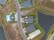 An aerial view of a cozy home on a well manicured lot with a water view at 256 Van Gogh Cv, Bradenton, FL 34212