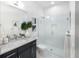 Elegant bathroom featuring a granite countertop, stylish vanity, and a modern glass-enclosed shower with white tiled walls at 256 Van Gogh Cv, Bradenton, FL 34212