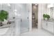 Modern bathroom featuring a glass shower, double vanity with granite counters, and striped accent wall at 256 Van Gogh Cv, Bradenton, FL 34212