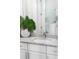 Stylish bathroom boasts granite countertops, white vanity, and a glass-enclosed shower, creating a spa-like retreat at 256 Van Gogh Cv, Bradenton, FL 34212