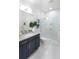 Modern bathroom showcasing a sleek vanity with granite countertops and a frameless glass-enclosed shower at 256 Van Gogh Cv, Bradenton, FL 34212